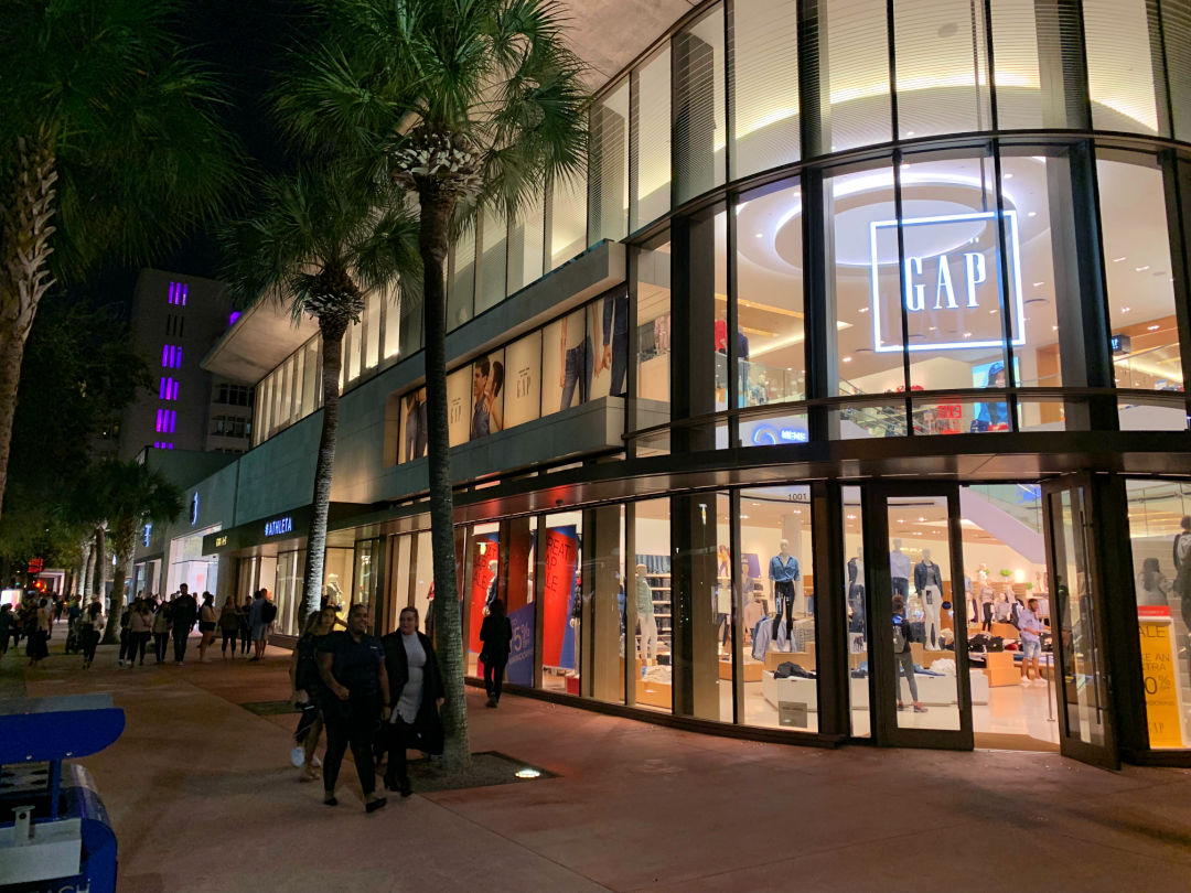 Shoppers strolling by the GAP flagship store at Lincoln Road